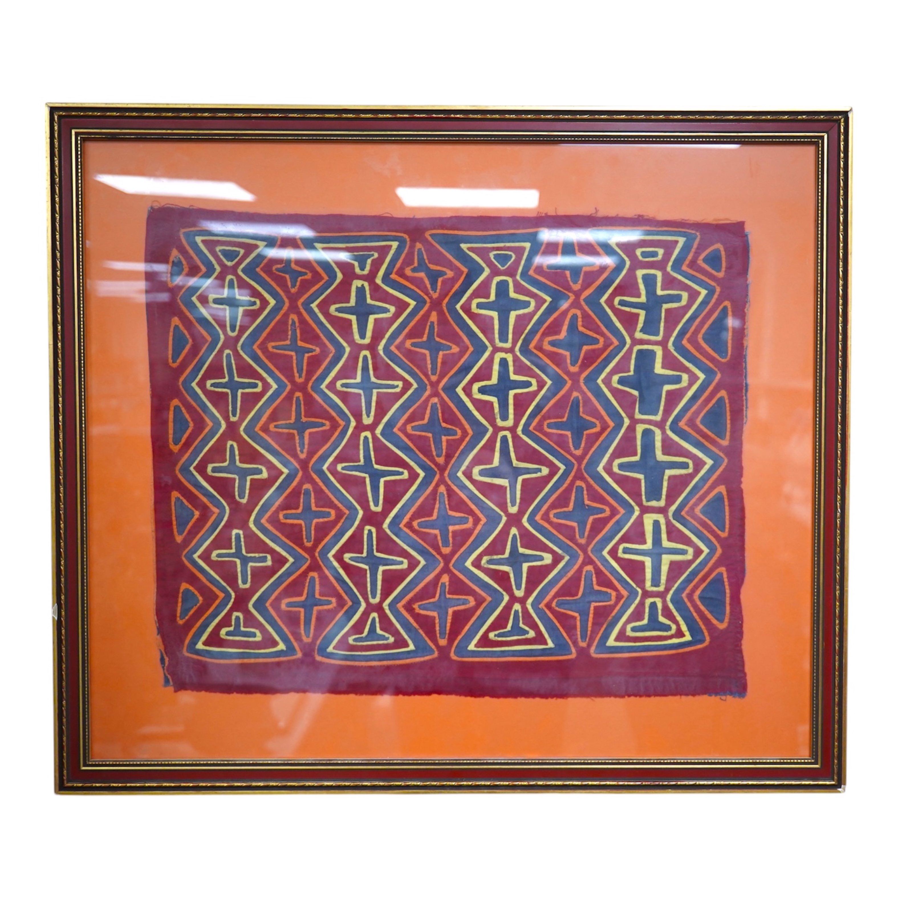 A framed Mola (Cuna Panama) appliqué worked shirt panel, mid 20th century, 45cm x 37cm. Condition - good